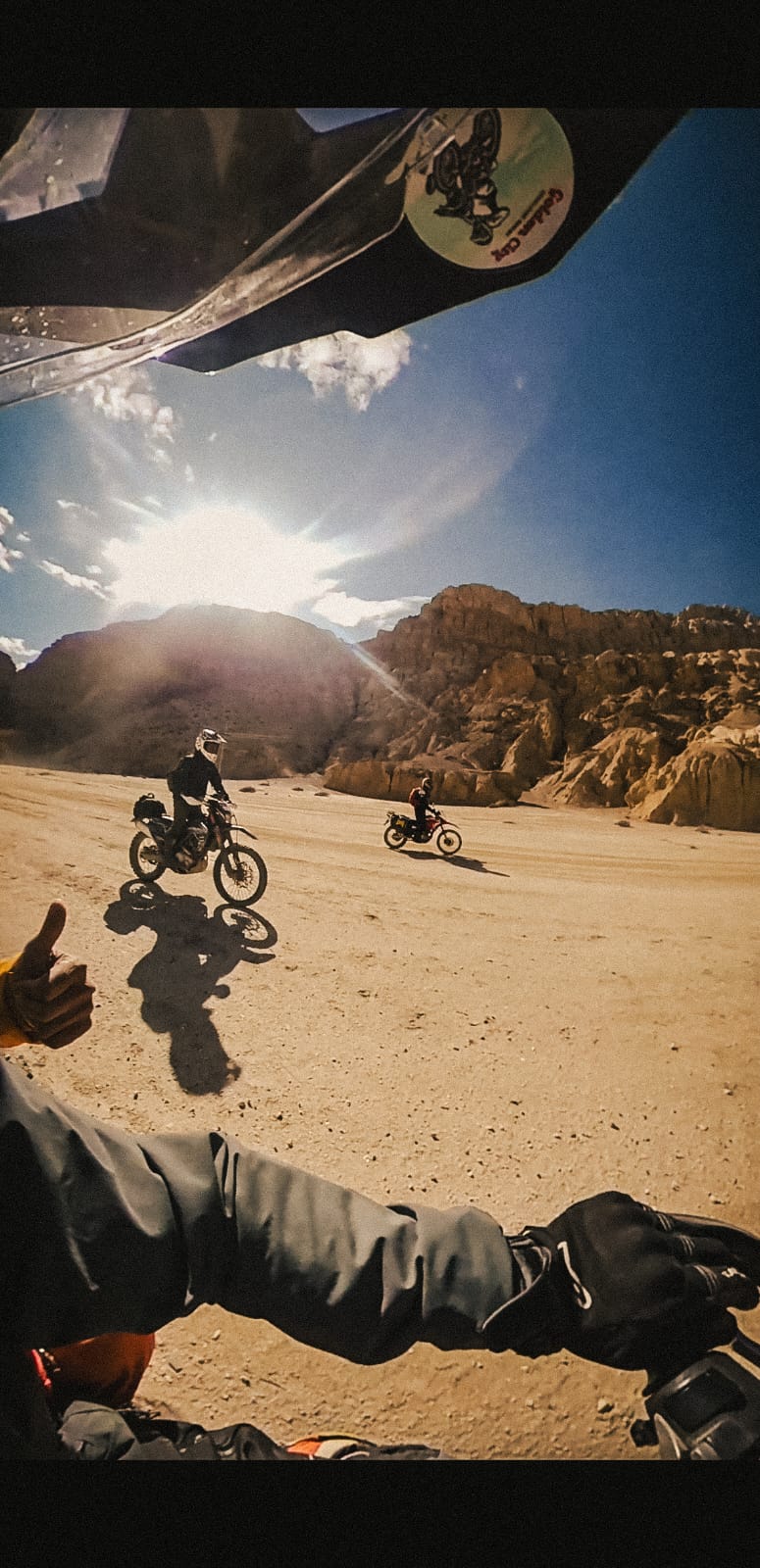 Point-of-view shot of riders crossing a barren sandy plain